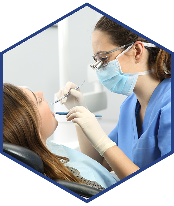 Dental hygienist working on teeth.